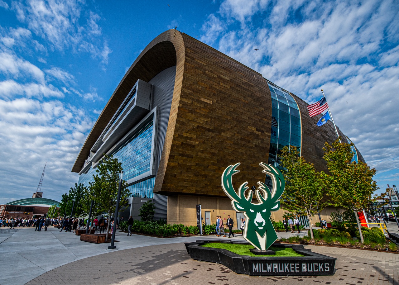 Exterior photograph of Milwaukee's Fiserv Forum with a statue of the Milwaukee Bucks deer in the foreground.