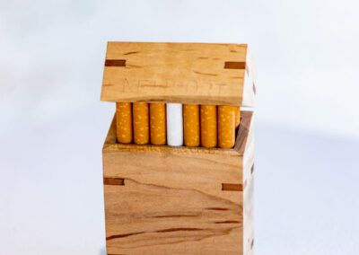 A woodworked cigarette box filled with Newport cigarettes.